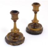 A pair of olive wood Jerusalem candlesticks with Hebrew and English script.