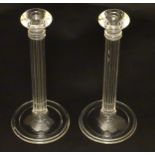 Tiffany & Co: A pair of pedestal glass candlesticks with receded columns ,