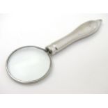 A silver plate magnifying glass.
