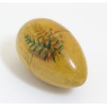 Mauchline ware / Fernware : A Turned treen needlework thimble case of egg form decorated with fern.