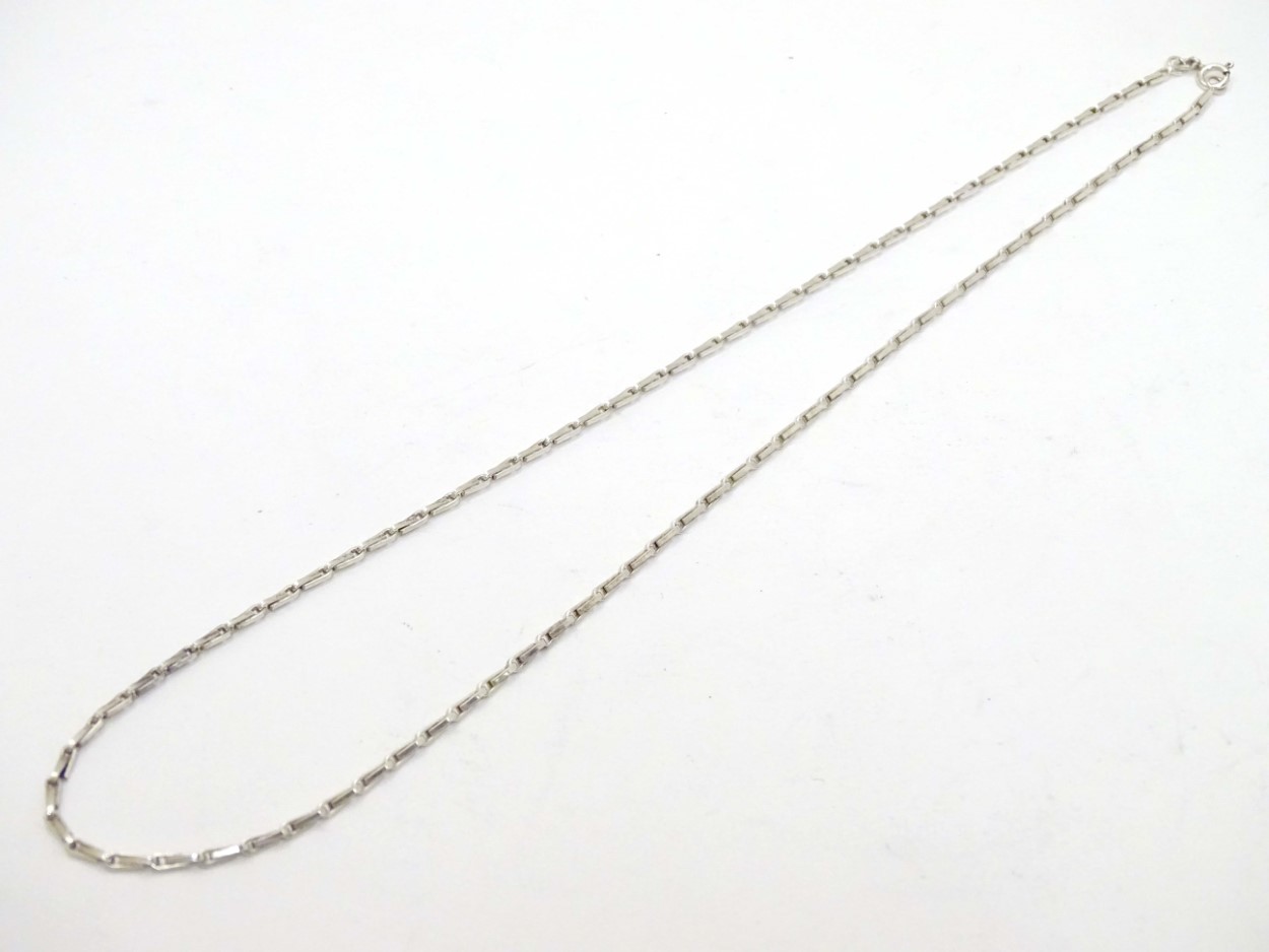 A silver and white metal chain.