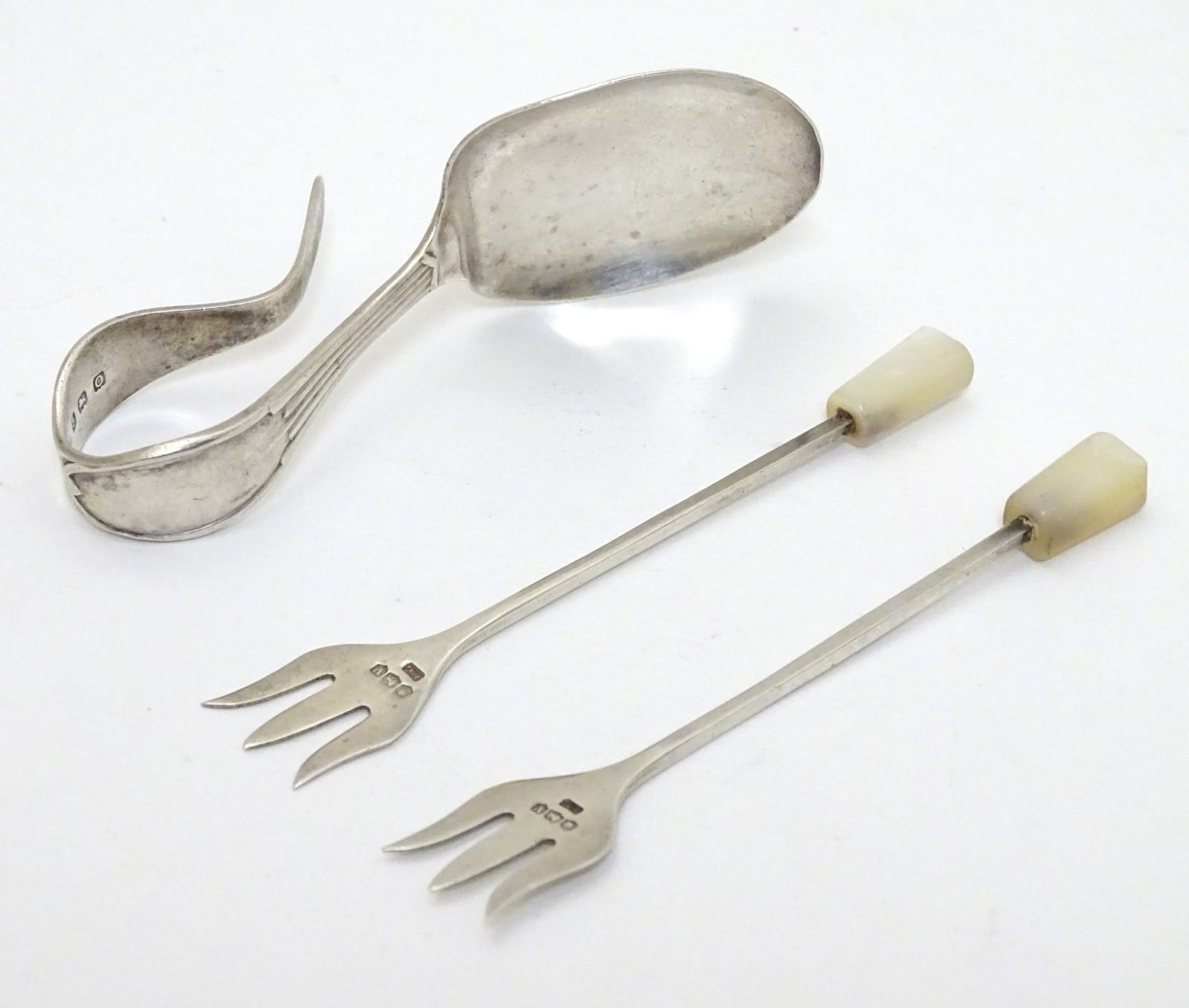 A pair of silver small pickle forks with mother of pearl handle,