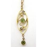 A yellow metal pendant and chain, the pendant set with peridot and seed pearls.