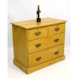 A late 19thC pine chest of drawers comprising two short over two long drawers with brass handles