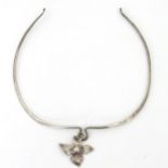 A white metal necklace of choker form with quatraform pendant.