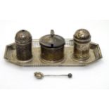 A silver cruet (matched set) comprising tray formed stand, salt and pepper pots and a mustard pot.