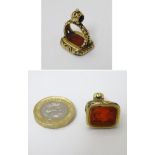 A 19thC gilt metal pendant fob seal with engraved carnelian armorial seal under.