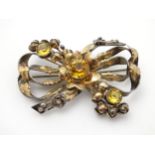 American Vintage Costume Jewelery by Hobé : A silver and gold plated brooch of stylised bow and