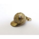 A 9ct gold pendant charm formed as a horse riding / jockey hat,