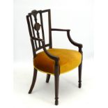 An early 20thC mahogany desk chair / carver in the Neo-Classical style with gadrooned cresting rail