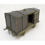 A scale model bronze and brass railway carriage with sliding doors 17 1/2" long x 9" high x 7 1/2"