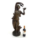 A 19thC bronzed terracotta figure of Hebe holding a wine ewer and having eagle (Zeus) at base both