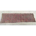 Rug / carpet : an old hand made Persian runner having a wine red ground with blues ,