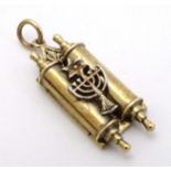 A 9ct gold charm formed as a Torah and decorated with Menorah 1 /4" long (8g) CONDITION: