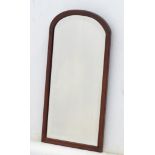 An early / mid 20thC narrow mahogany mirror with bevelled edge and arched top 19" wide x 22 ¼"