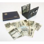 A folding stereoscopic viewer, together with a collection of photographic cards,