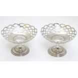 A pair of silver pedestal bon bon dishes with pierced decoration hallmarked Birmingham 1912 maker A