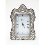 A small wooden cased mantle clock with silver surround hallmarked Sheffield 1989 maker Carrs of