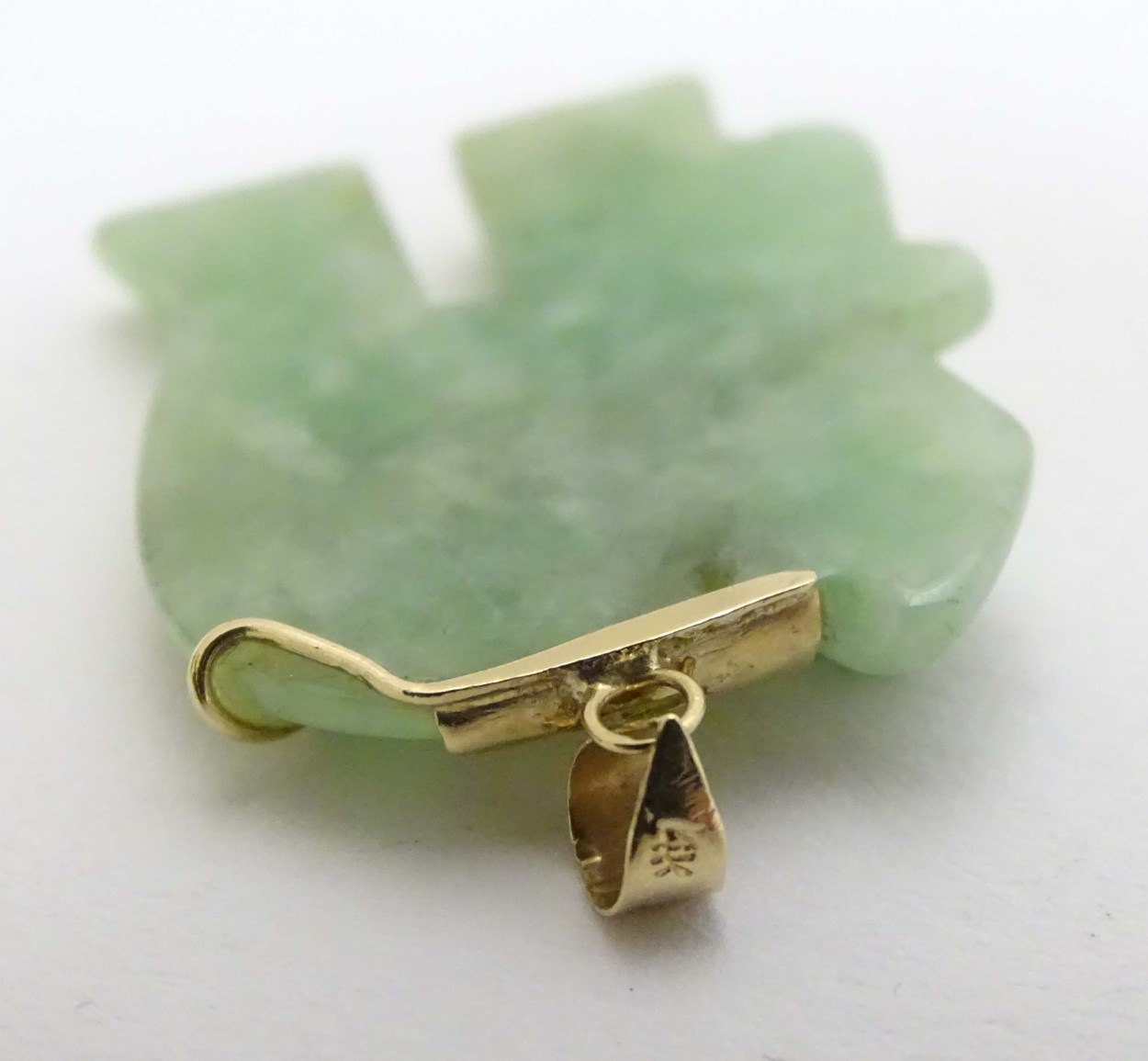 A carved jade pendant formed as a elephant with jade cabochon eye and 14kt gold mounts. - Image 2 of 4