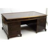 A large early 20thC double pedestal desk with four short drawers beside single central drawer