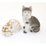 Two ceramic models of cats, one seated, one recumbent. Height of the seated model: approx.