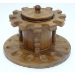 Pipe smoking: A mid-20thC fruitwood circular pipe rack with internal and removable tobacco jar,