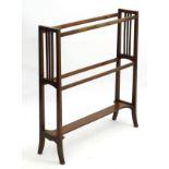 Arts & Crafts: An early 20thC mahogany towel rail with slatted sides and shaped stretcher.