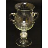 Pedestal glass with coin : a two handled pedestal early 20 th C glass having a ground pontil scar,