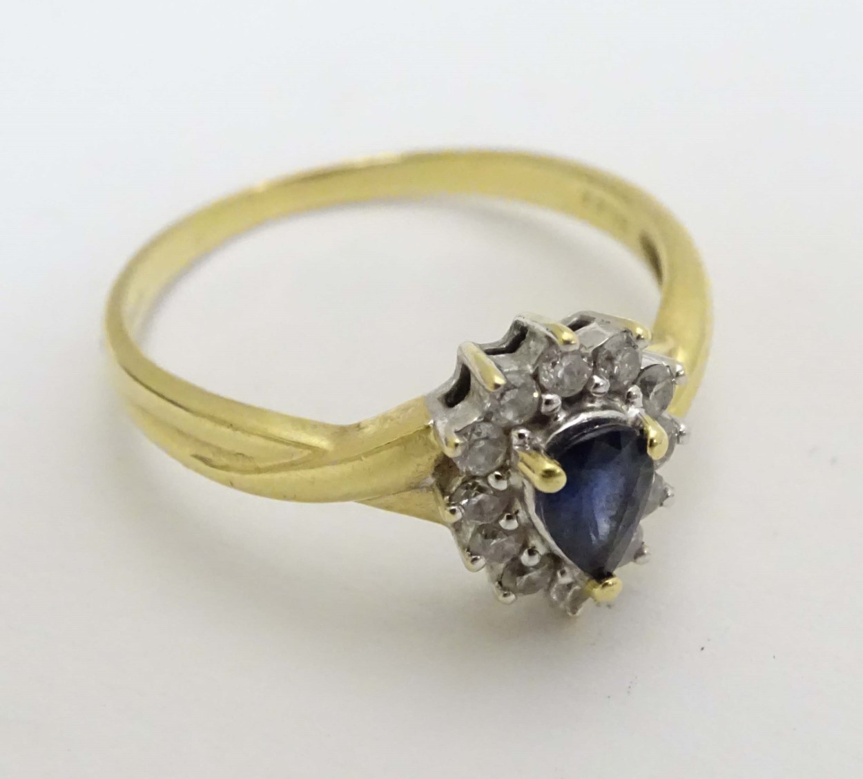 An 18ct gold ring set with central blue stone bordered by diamonds CONDITION: - Image 3 of 6