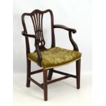 A late 19thC mahogany open armchair / desk chair with camel back top rail,