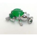 A white metal pendant formed as a frog set with green jade like cabochon 1" long