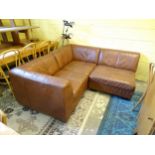 A faux tan leather 3 section modular settee ( 2 corners and a mid section ) bearing fire retardant