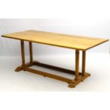 An early / mid 20thC oak Heals Tilden table with overhanging top and double column ends,