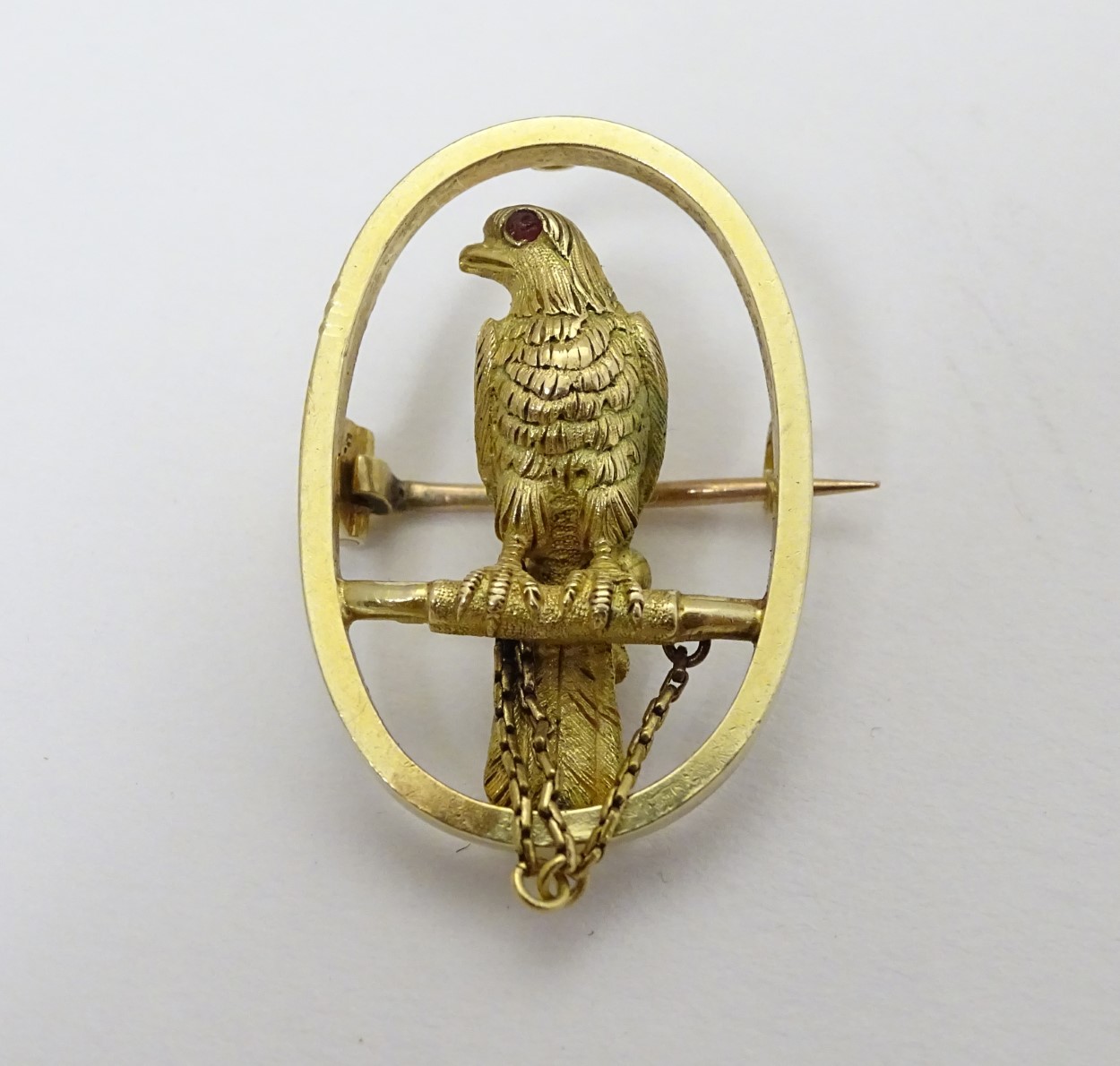 A 15ct gold brooch of oval form with falcon bird to centre 1 1/4" high CONDITION: