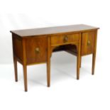 A Regency style mahogany bow fronted sideboard with long central drawer flanked to both sides by