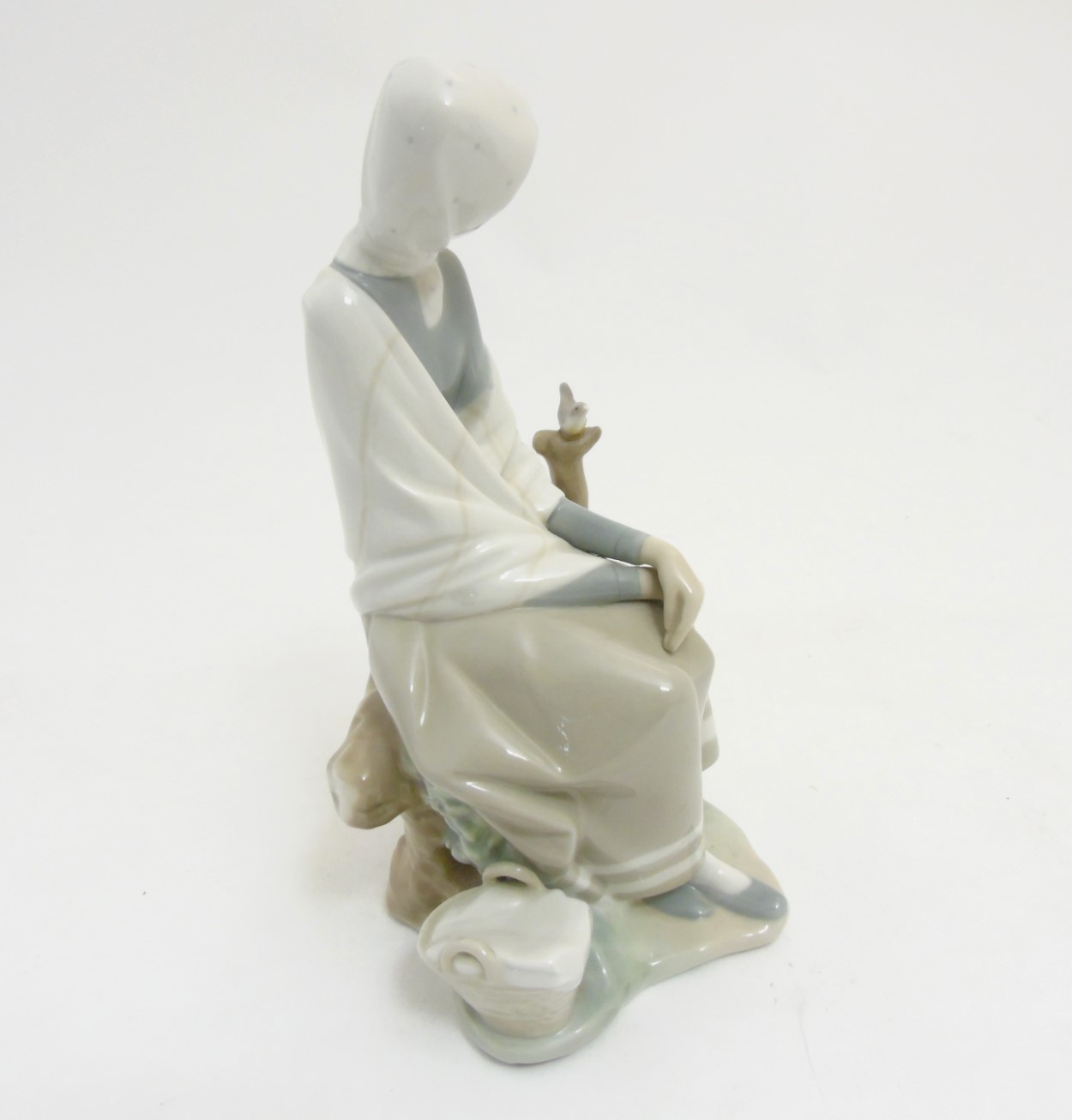 A Lladro 'New Shepherdess' figurine of a girl sat watching a bird, makers mark to base, - Image 4 of 8