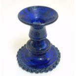 Scandinavian Studio Pottery: A blue mottled candlestick with beaded decoration to base rim,