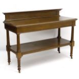 A late 19thC / early 20thC oak two tier dumb waiter / buffet,