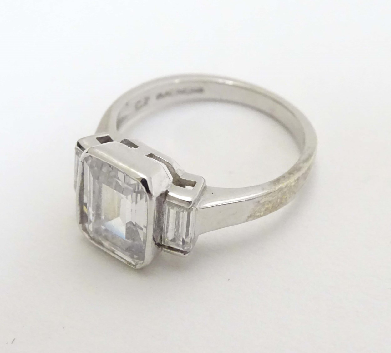 A 9ct white gold ring set with white stone flanked by 2 further stones CONDITION: