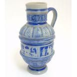 A German Westerwald style salt glazed ewer jug with molded relief of folklore scenes and other