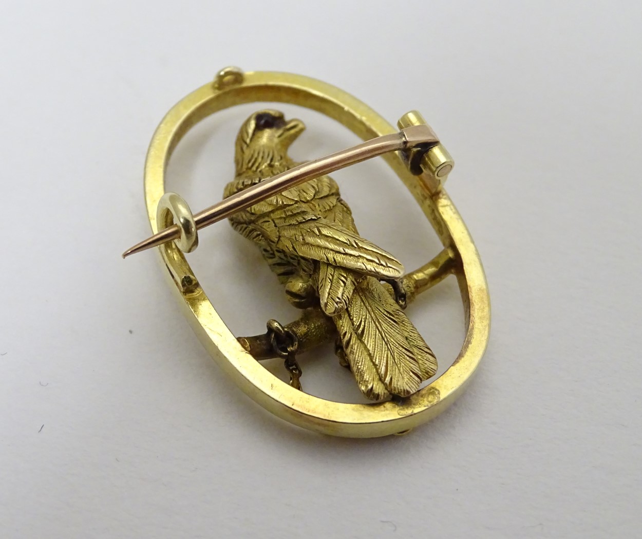 A 15ct gold brooch of oval form with falcon bird to centre 1 1/4" high CONDITION: - Image 2 of 5