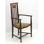 An Arts and Crafts Liberty style mahogany inlaid high back open armchair with shaped arms and legs