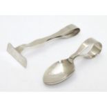 A childs silver spoon and pusher,