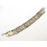 A silver charm bracelet set with approx 21 three pence coins dating from 1892 to 1941