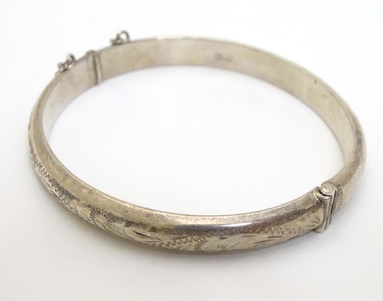 A silver bangle with engraved decoration. Hallmarked Birmingham 1977. Maker R. J. Crafts.