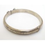 A silver bangle with engraved decoration. Hallmarked Birmingham 1977. Maker R. J. Crafts.