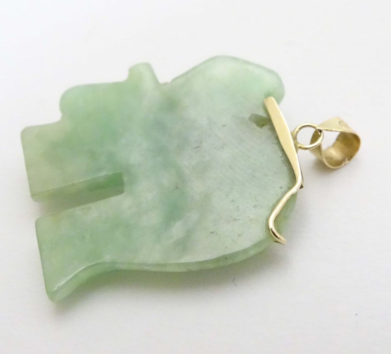 A carved jade pendant formed as a elephant with jade cabochon eye and 14kt gold mounts. - Image 4 of 4