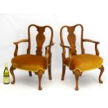 A pair of early 20thC walnut Queen Anne style low chairs with vase shaped back splat and standing