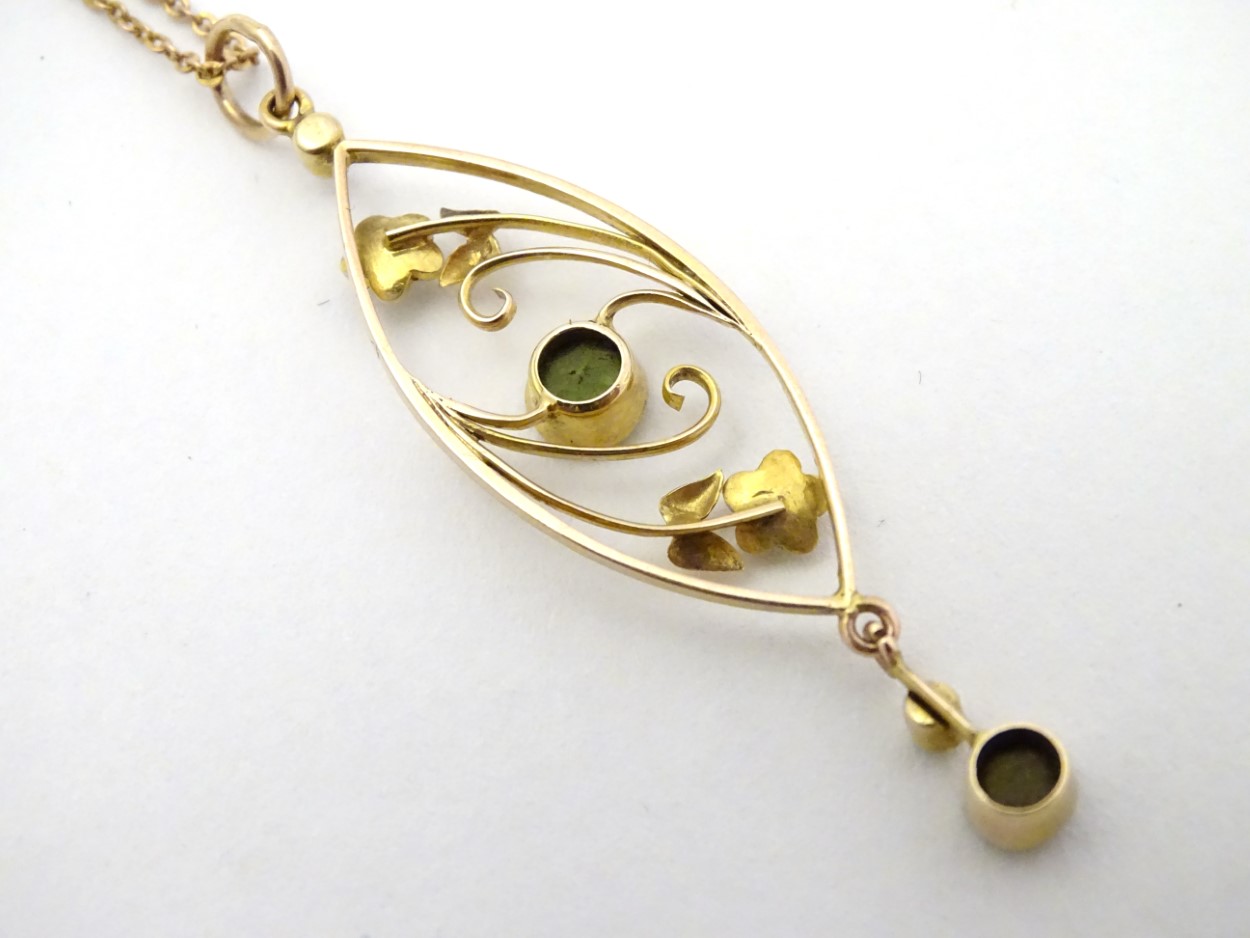 A yellow metal pendant and chain, the pendant set with peridot and seed pearls. - Image 2 of 4