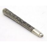 A white metal cheroot holder with filigree style decoration.